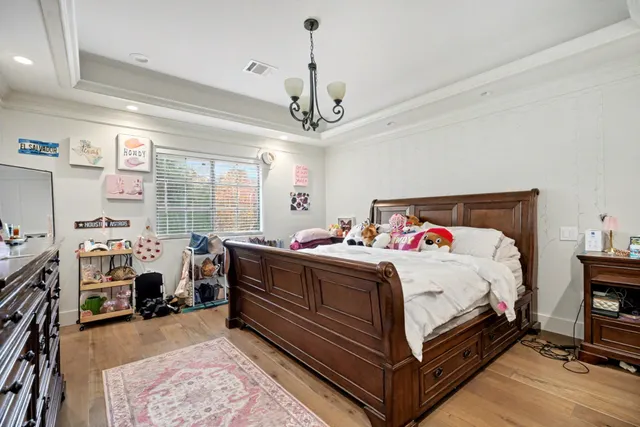 a bed room with a bed and a chandelier