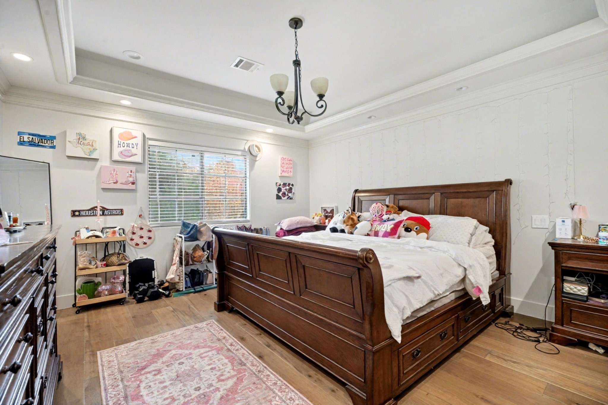 8515 Edgemoor Drive Houston, TX 77036 - Photo 18 of 33 a bed room with a bed and a chandelier