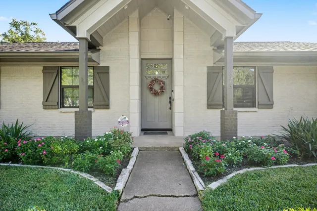 a front view of a house with garden