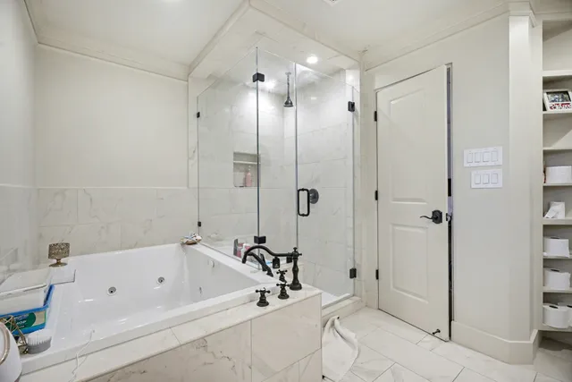 a bathroom with a bathtub and a shower
