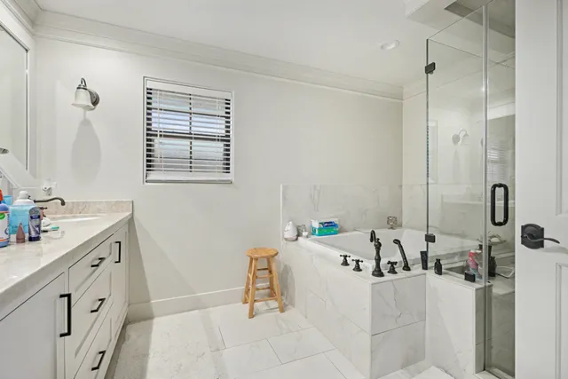 a bathroom with a tub sink and mirror