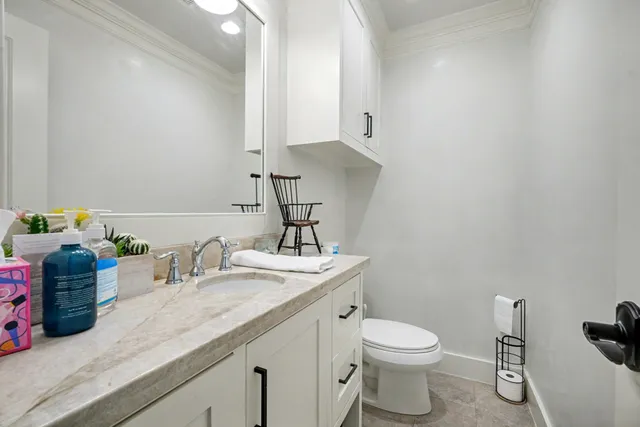 a bathroom with a toilet sink and mirror