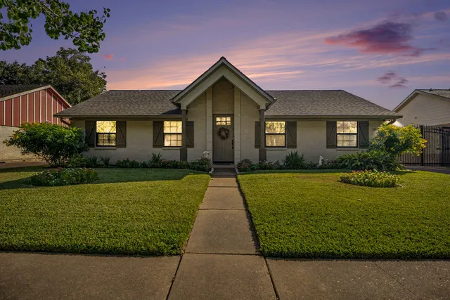 a view of a brick house with a yard