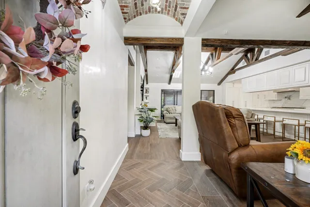 a living room with furniture and a chandelier