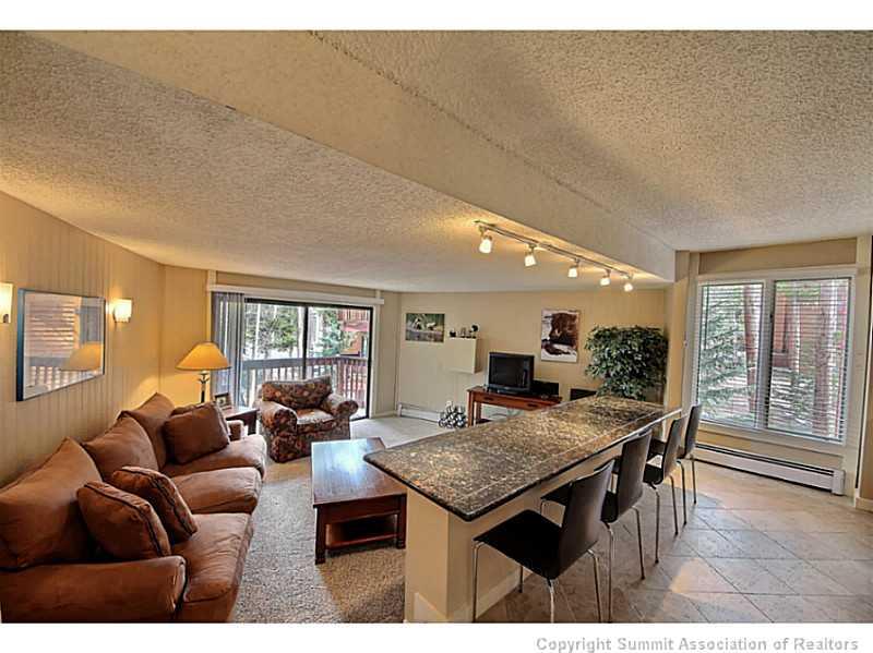 a living room with furniture a window and a table