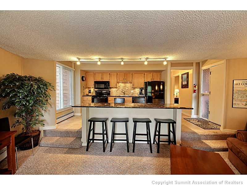 1100 Ski Hill Road, Unit 36 Breckenridge, CO 80424 - Photo 2 of 17 a kitchen with a table and chairs in it