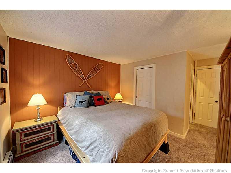 1100 Ski Hill Road, Unit 36 Breckenridge, CO 80424 - Photo 12 of 17 a bedroom with a bed and a night stand