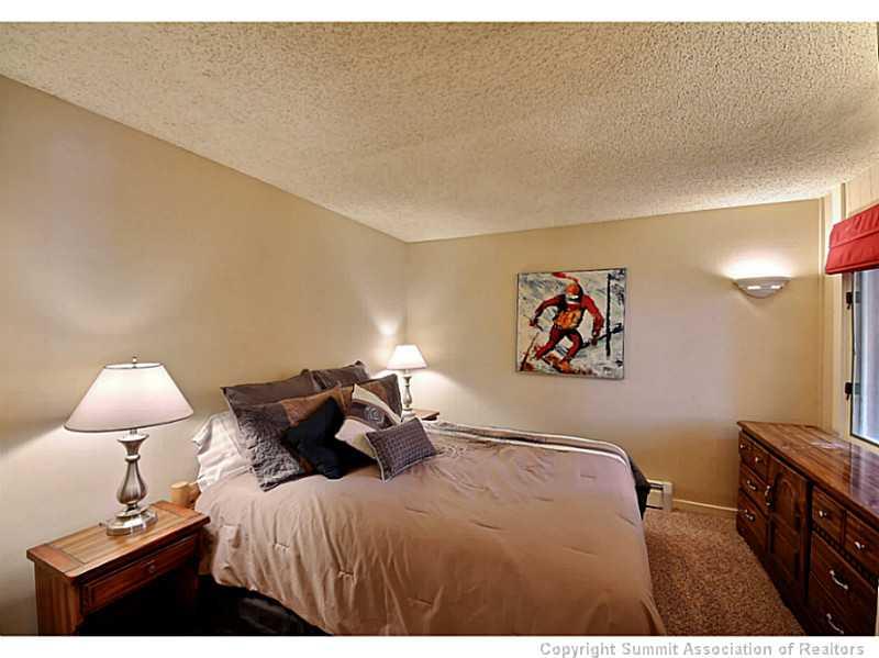 1100 Ski Hill Road, Unit 36 Breckenridge, CO 80424 - Photo 14 of 17 a bedroom with a bed and a flat screen tv