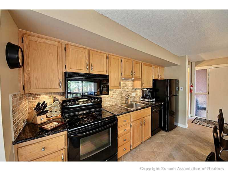 1100 Ski Hill Road, Unit 36 Breckenridge, CO 80424 - Photo 6 of 17 a kitchen with a sink stove and refrigerator