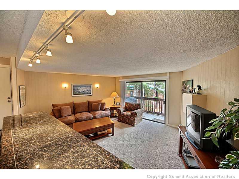 1100 Ski Hill Road, Unit 36 Breckenridge, CO 80424 - Photo 7 of 17 a living room with furniture and a fireplace