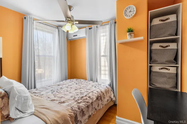 a bedroom with a bed and a lamp with wooden floor