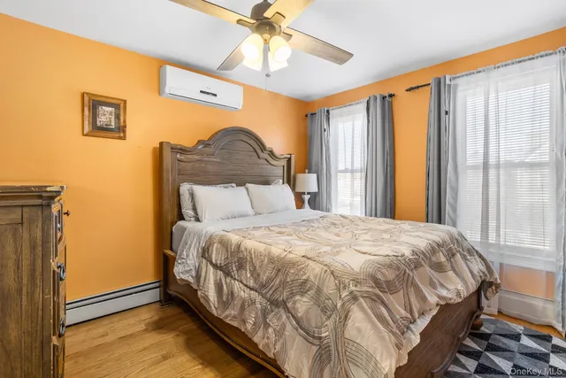 a bed sitting in a bedroom next to a window