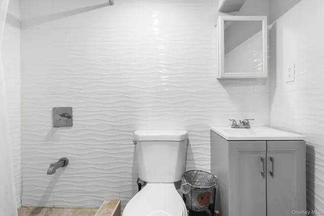 a bedroom with bed and wooden floor