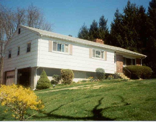 66 Birch Hill Road Newtown, CT 06470 - Photo 1 of 1 a front view of a house with a yard