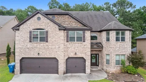 a front view of a house with yard