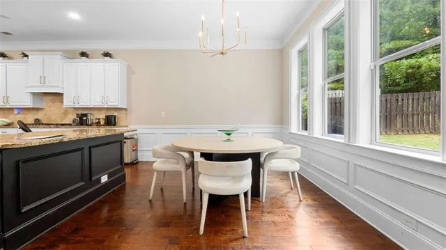 a kitchen with a table chairs stove and cabinets