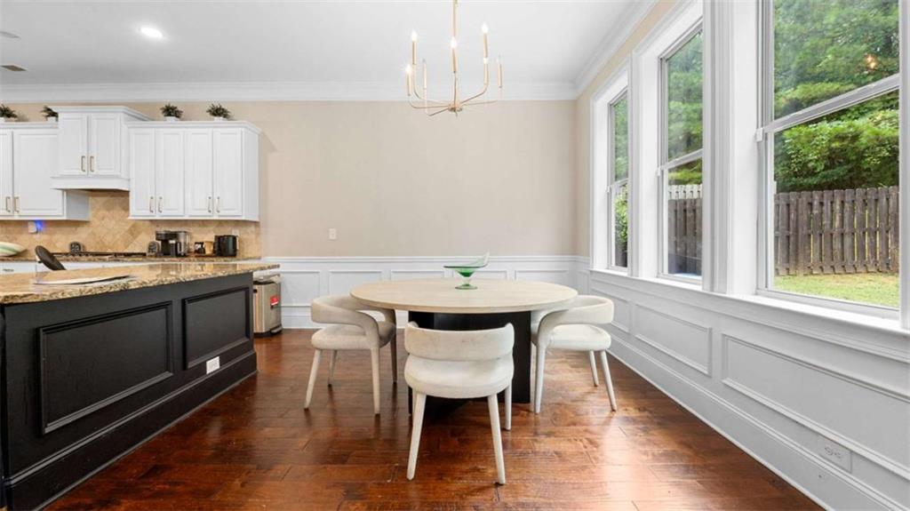 2328 Austin Common Way Dacula, GA 30019 - Photo 11 of 52 a kitchen with a table chairs stove and cabinets