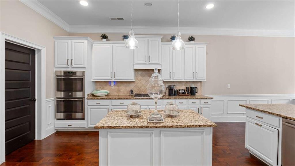 2328 Austin Common Way Dacula, GA 30019 - Photo 16 of 52 a kitchen with stainless steel appliances granite countertop a sink stove and refrigerator