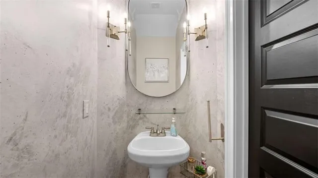 a bathroom with a sink toilet and a mirror