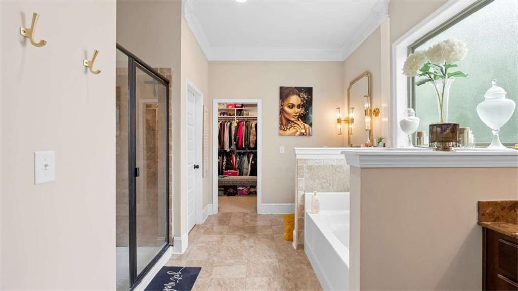 2328 Austin Common Way Dacula, GA 30019 - Photo 23 of 52 a en suite bathroom with a sink a mirror and a shower