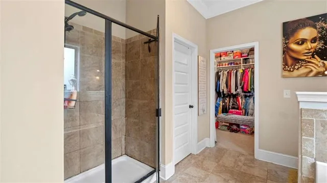 a view of walk in closet with clothes and shoes