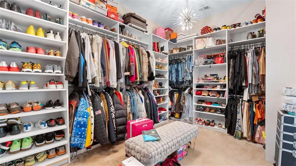 2328 Austin Common Way Dacula, GA 30019 - Photo 27 of 52 a view of walk in closet with clothes and shoes