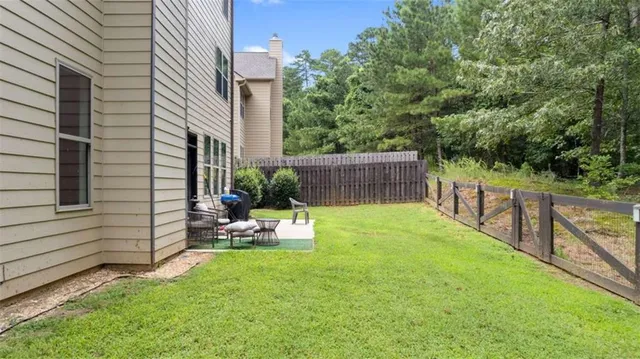 a view of a backyard with sitting area