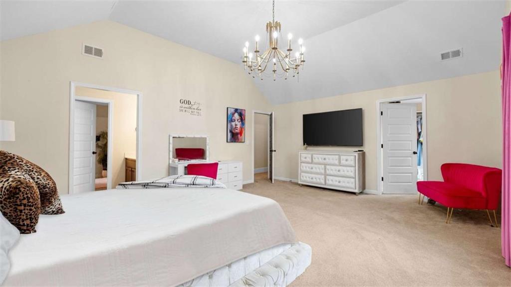 2328 Austin Common Way Dacula, GA 30019 - Photo 34 of 52 a bedroom with a bed and a flat screen tv