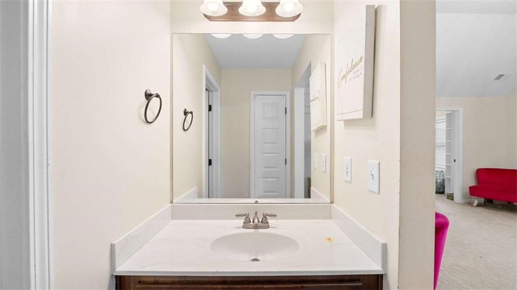 2328 Austin Common Way Dacula, GA 30019 - Photo 35 of 52 a bathroom with a sink and a mirror