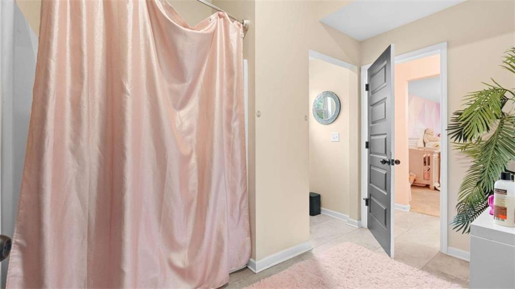2328 Austin Common Way Dacula, GA 30019 - Photo 36 of 52 a bathroom with a shower curtain and a curtain