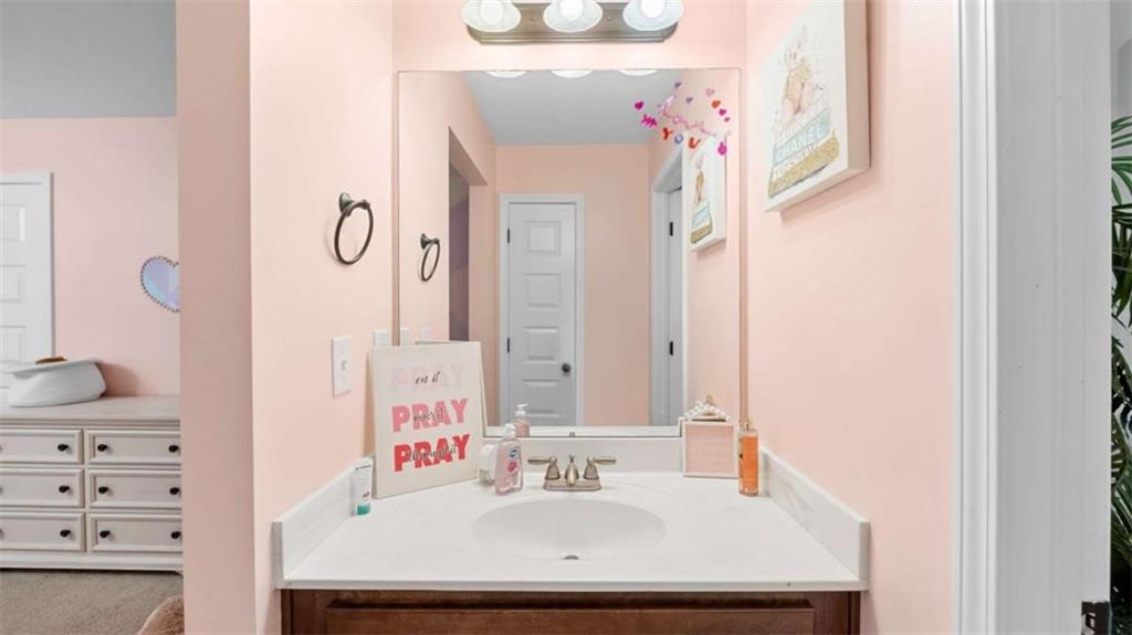2328 Austin Common Way Dacula, GA 30019 - Photo 37 of 52 a bathroom with a sink vanity and a mirror