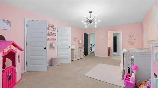 a bedroom with a bed chandelier and a window