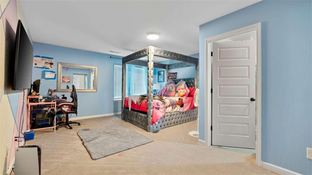 2328 Austin Common Way Dacula, GA 30019 - Photo 44 of 52 a bed room with furniture and a flat screen tv