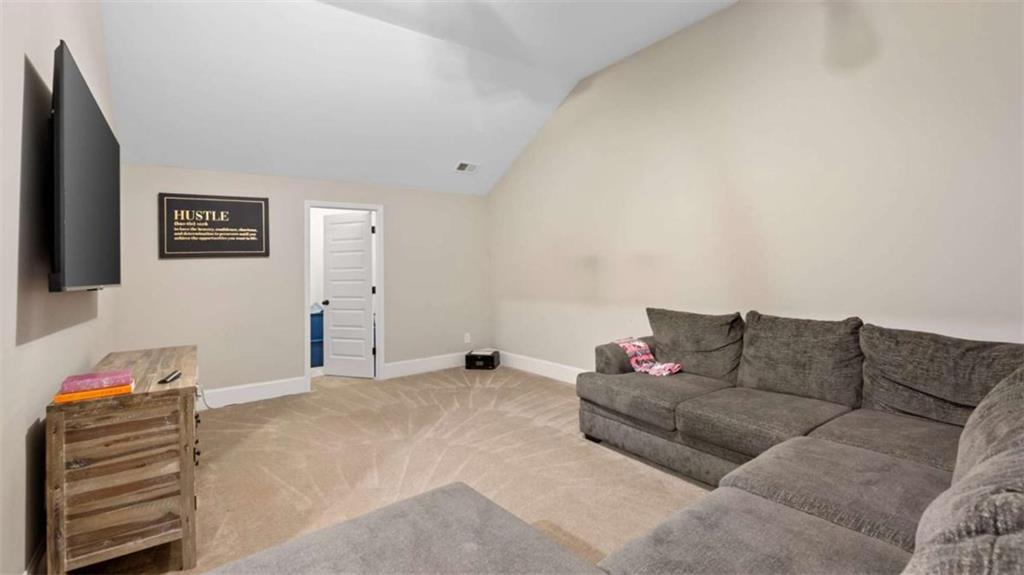 2328 Austin Common Way Dacula, GA 30019 - Photo 46 of 52 a living room with furniture and a couch