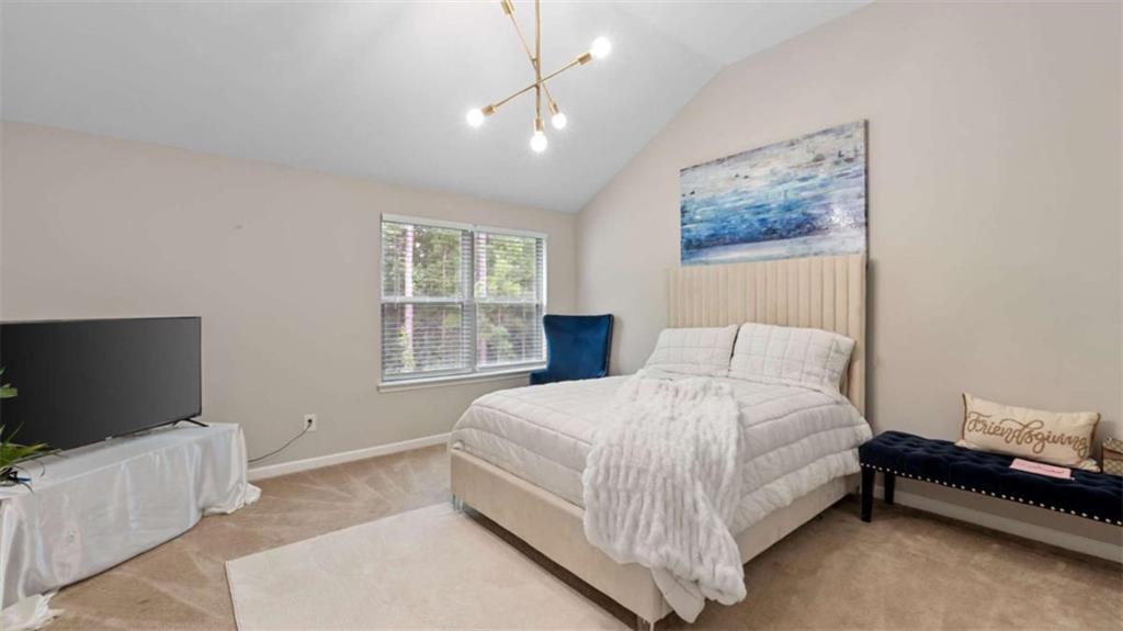 2328 Austin Common Way Dacula, GA 30019 - Photo 48 of 52 a bedroom with a bed and a flat screen tv