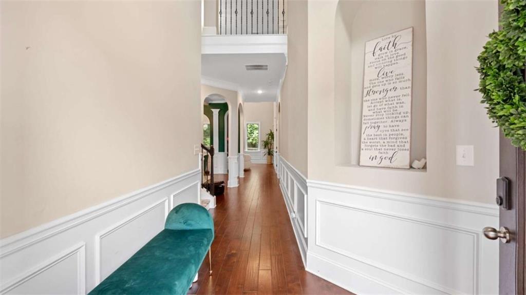 2328 Austin Common Way Dacula, GA 30019 - Photo 7 of 52 a view of a hallway with wooden floor and staircase