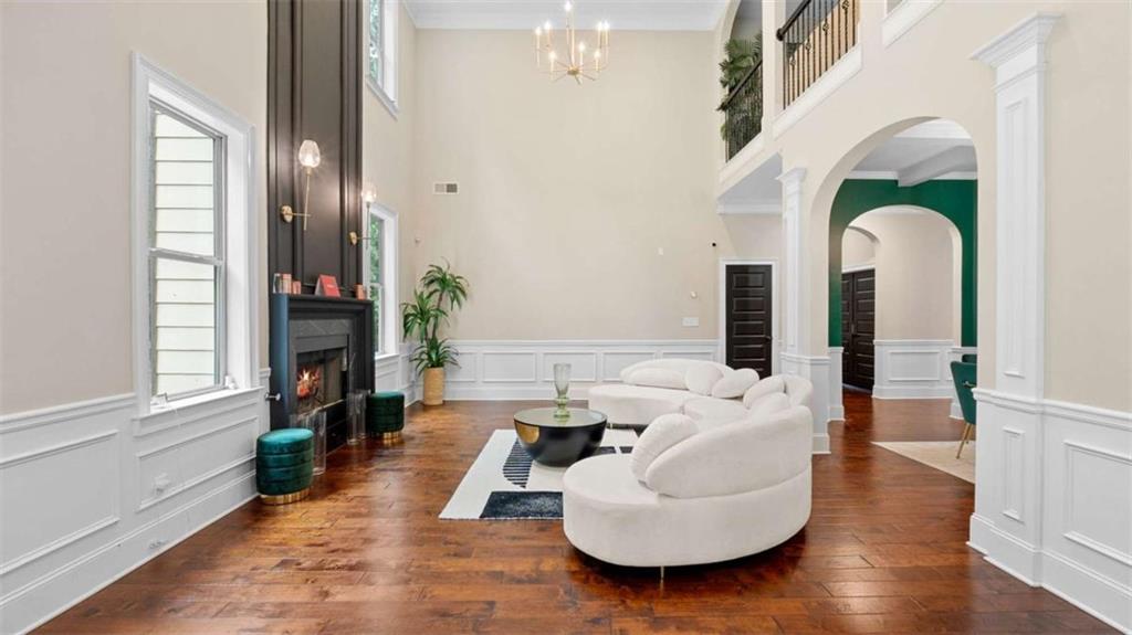 2328 Austin Common Way Dacula, GA 30019 - Photo 10 of 52 a living room with furniture a large window and wooden floor