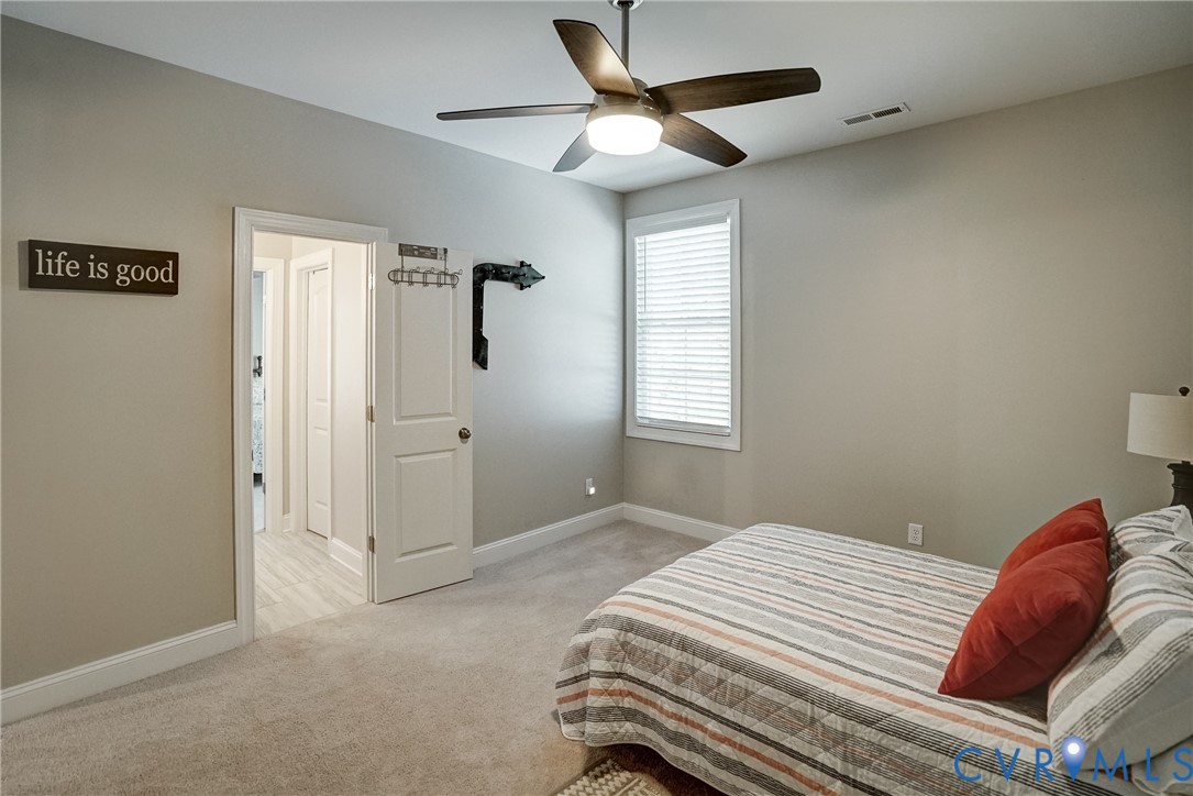 4669 Woburn Road Providence Forge, VA 23140 - Photo 53 of 78 a bedroom with a bed and a chandelier