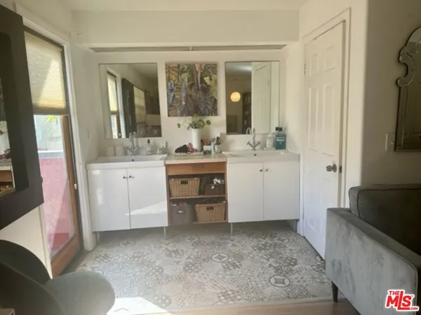 a large bathroom with a sink a toilet a mirror and shower