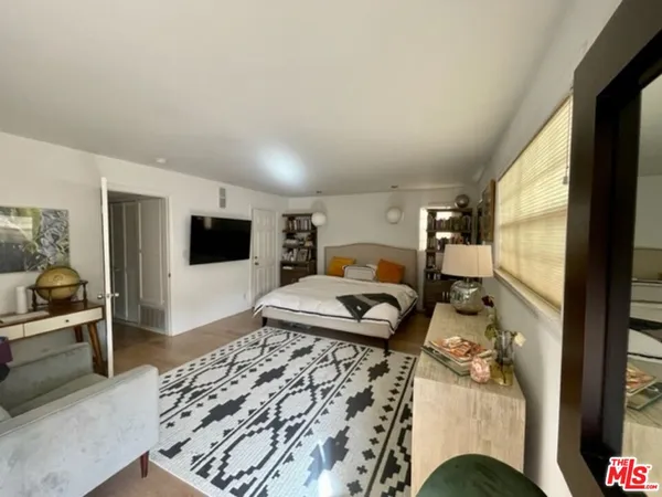 a bedroom with furniture and a flat screen tv