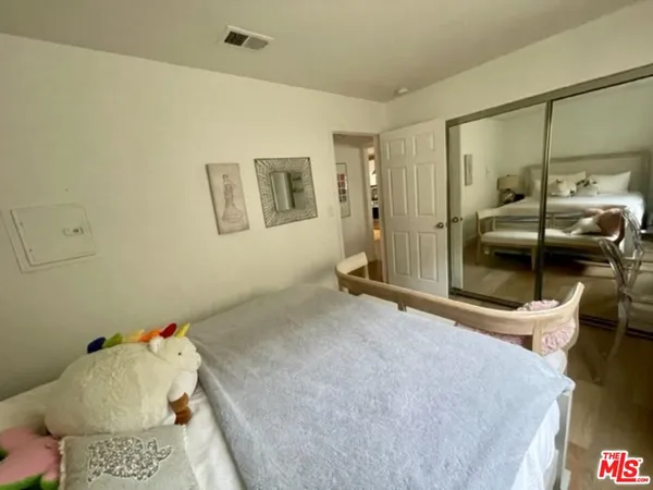 a bedroom with a bed and a view of bathroom