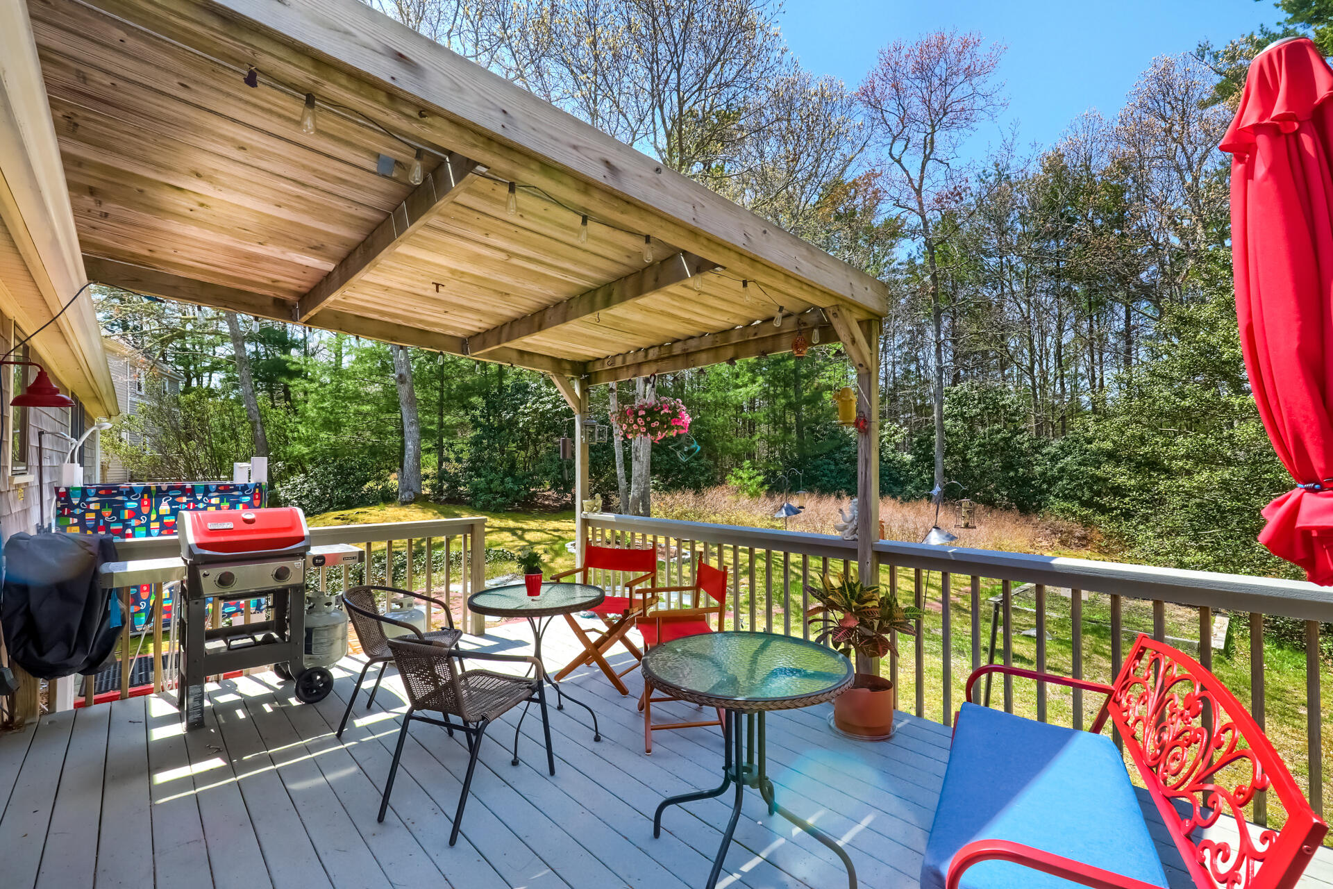 48 Gunstock Road Osterville, MA 02655 - Photo 24 of 28 a view of a patio with table and chairs potted plants with wooden floor and fence