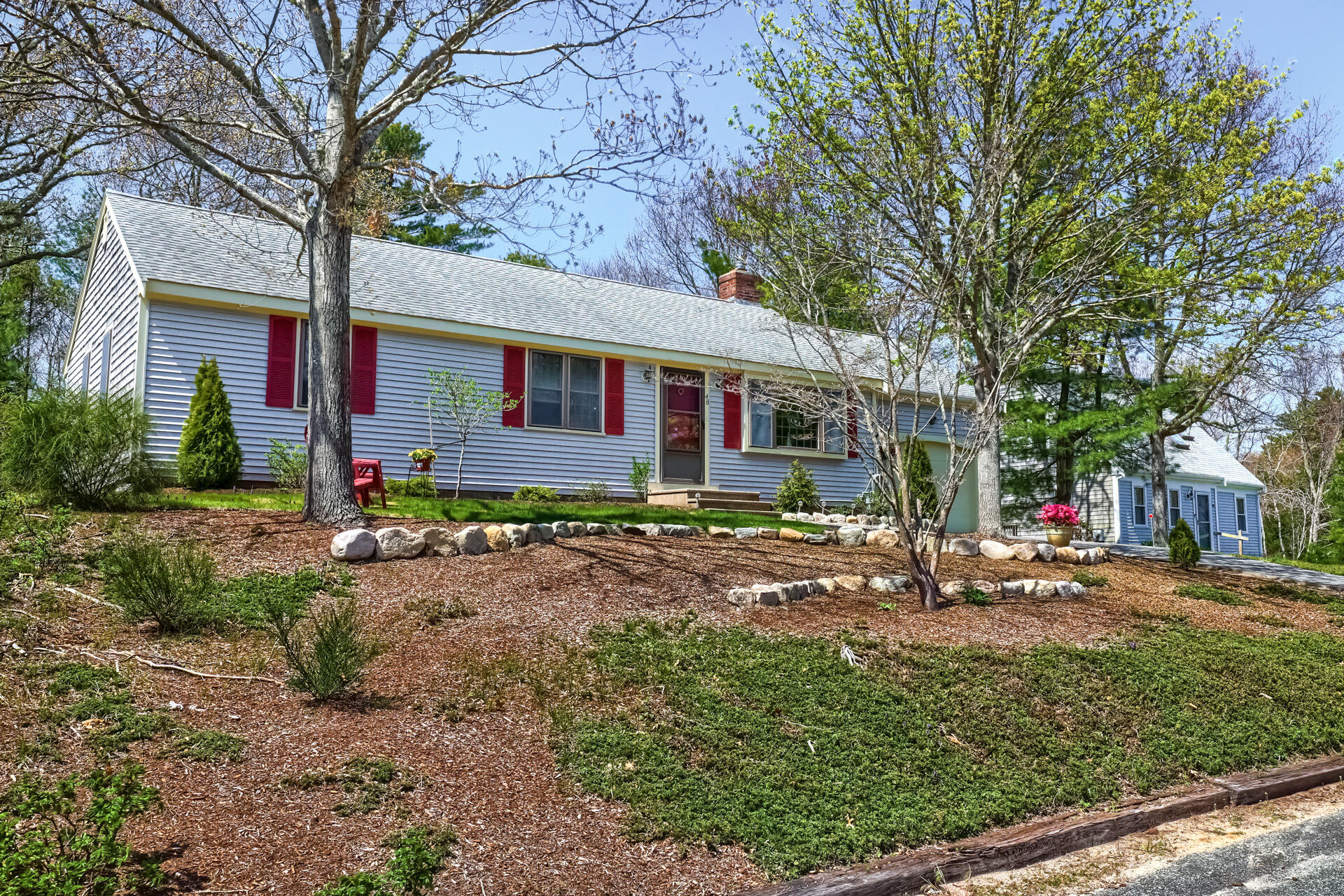 48 Gunstock Road Osterville, MA 02655 - Photo 3 of 28 a front view of a house with a yard and potted plants