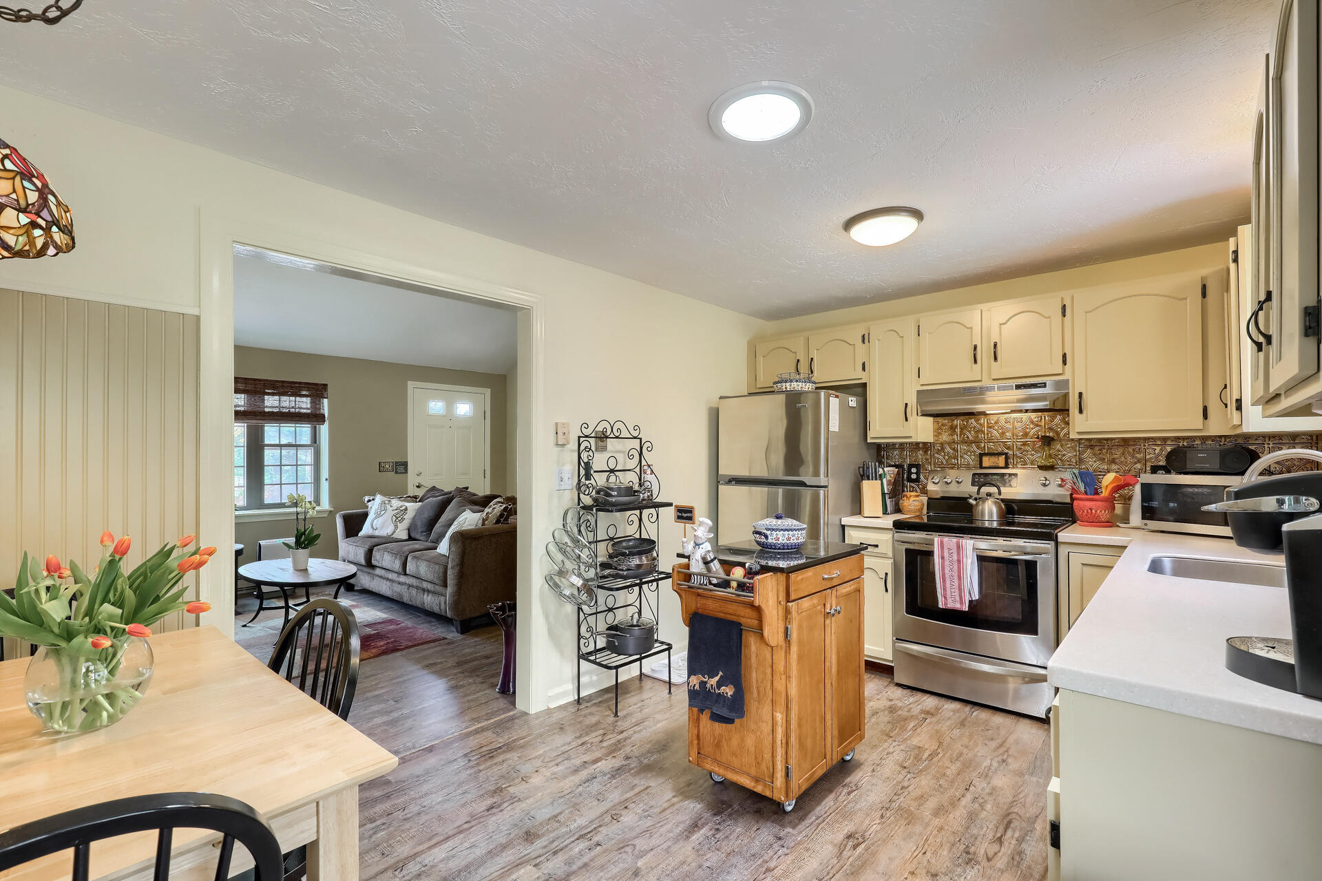 48 Gunstock Road Osterville, MA 02655 - Photo 10 of 28 a kitchen with stainless steel appliances kitchen island granite countertop a stove top oven a sink a dining table and chairs