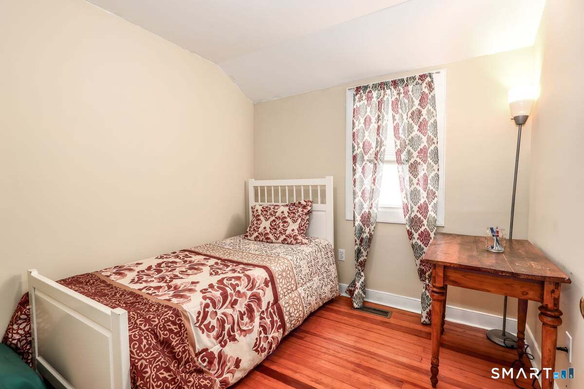 70 Dodgingtown Road Bethel, CT 06801 - Photo 11 of 27 a bedroom with a bed and a table in it