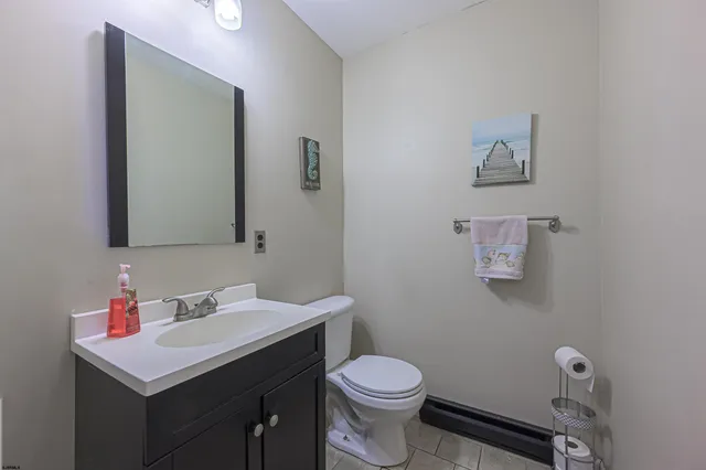 a bathroom with a sink mirror and toilet