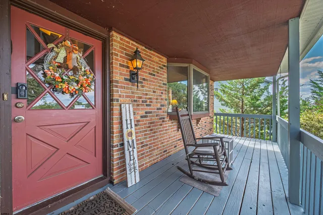 a view of a balcony with chairs and wooden floor