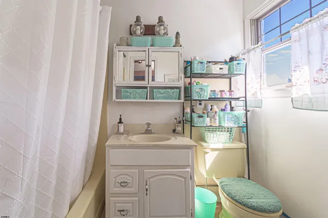 a bathroom with a granite countertop sink a toilet and a mirror