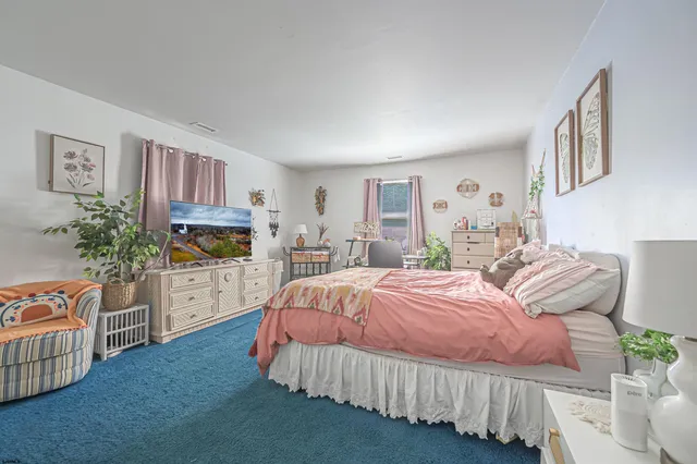 a bedroom with furniture and a flat screen tv