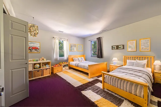 a bedroom with furniture and a wooden floor